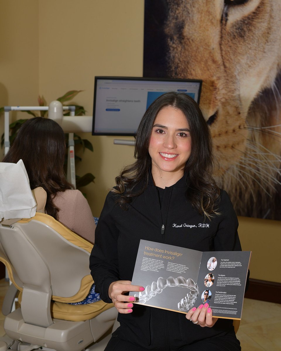 Karol Ortegon, RDH, holding the Invisalign treatment guide at Sunset Smiles in Jupiter, FL