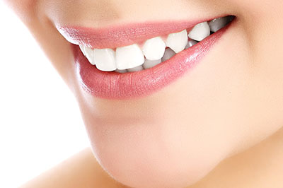 The image shows a close-up view of a person s face with a focus on their teeth, which are white and appear to be well-maintained.